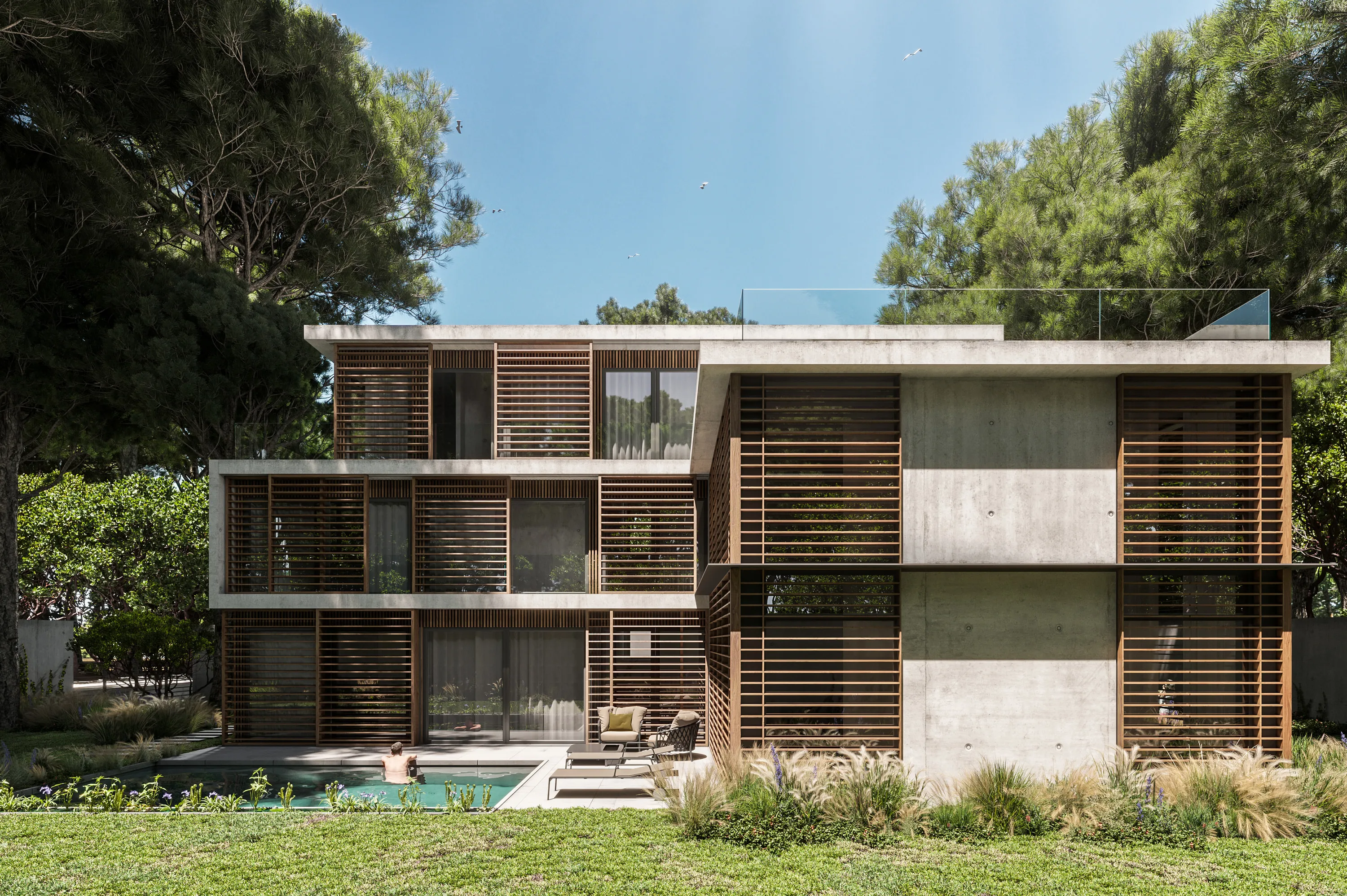 Front view of the concrete and wood villa rising among the dunes of Castelldefels