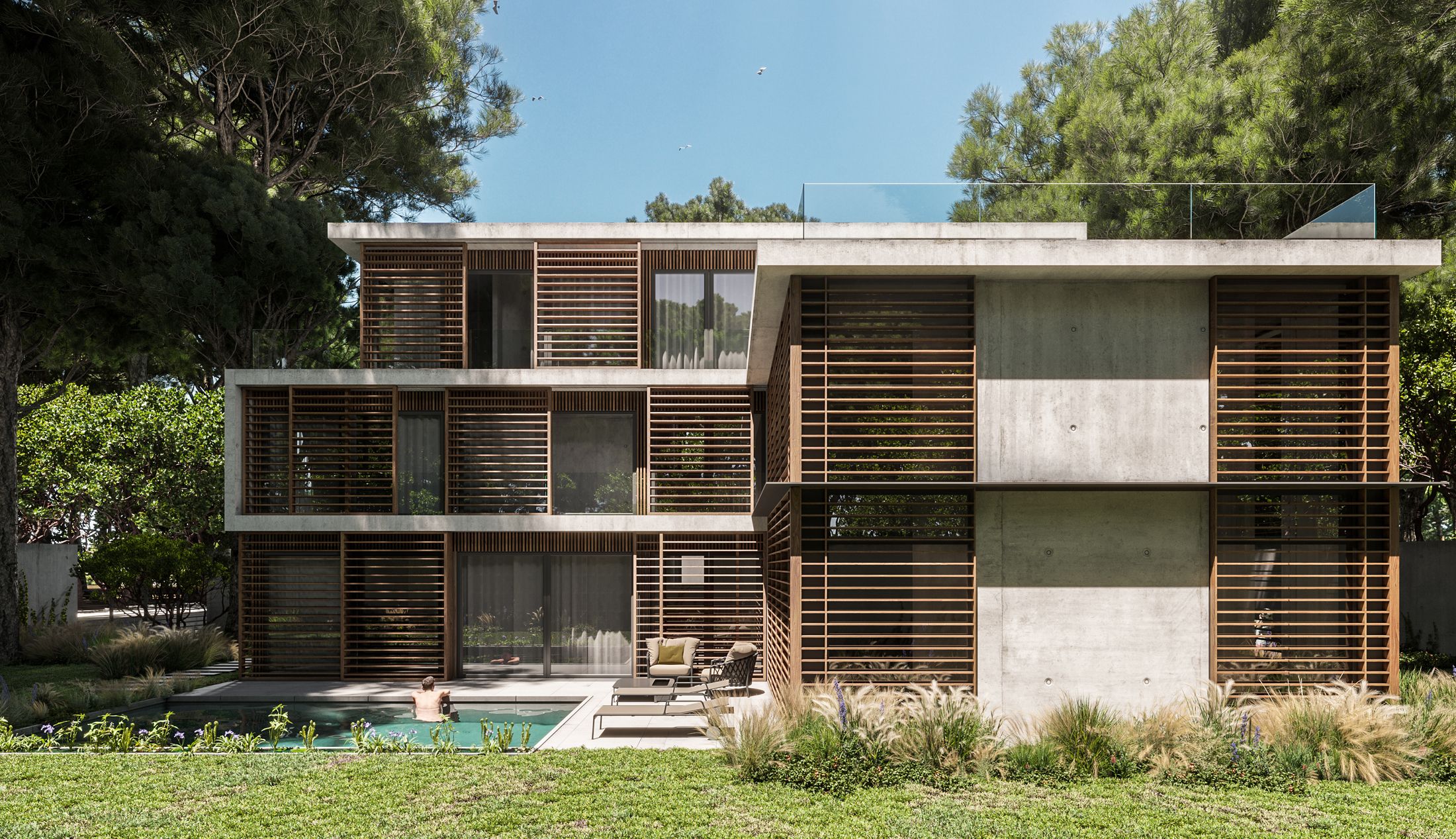 Vista frontal de la villa de hormigón y madera entre las dunas de Castelldefels