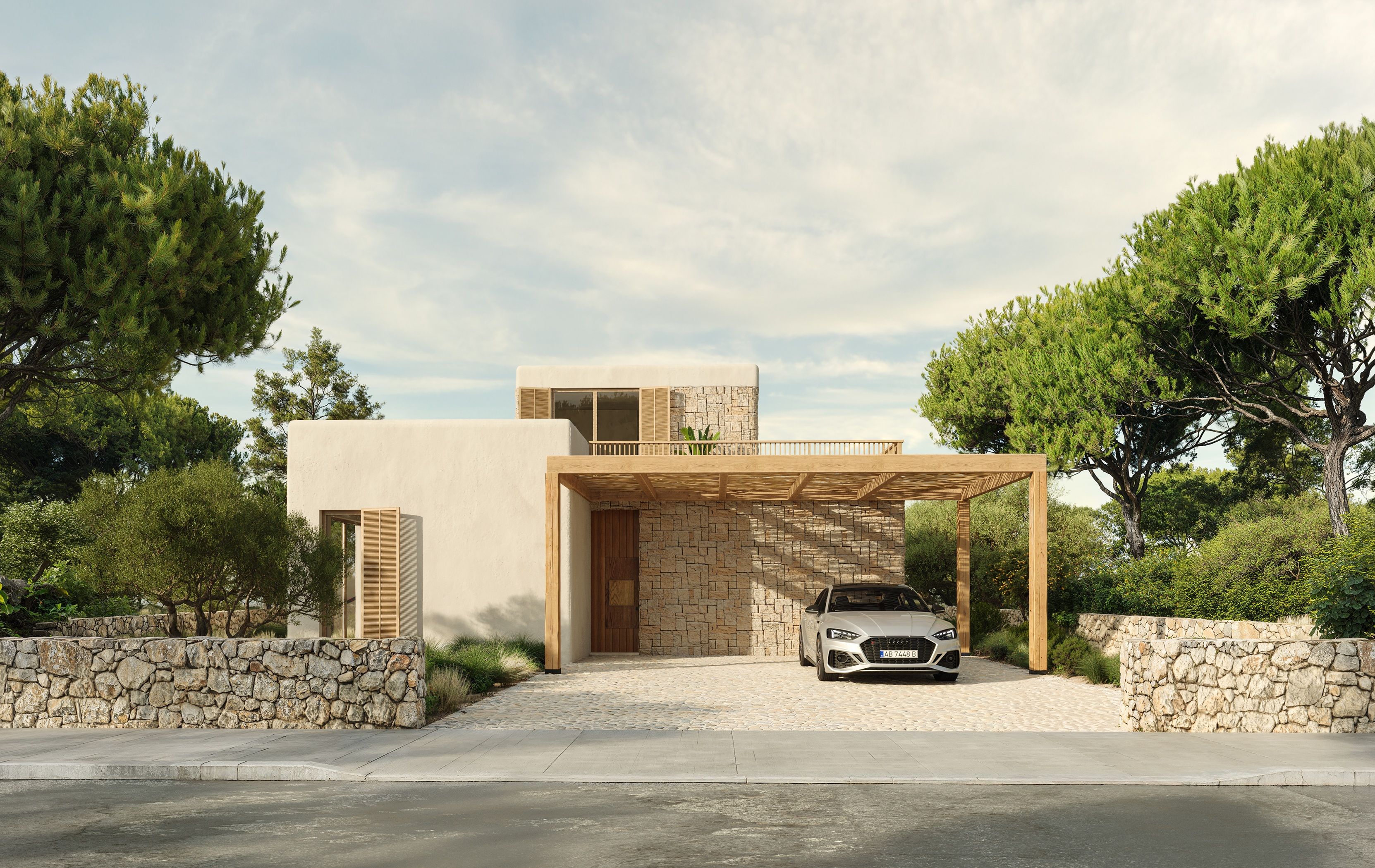 La villa vista desde la entrada, rodeada de pinos centenarios