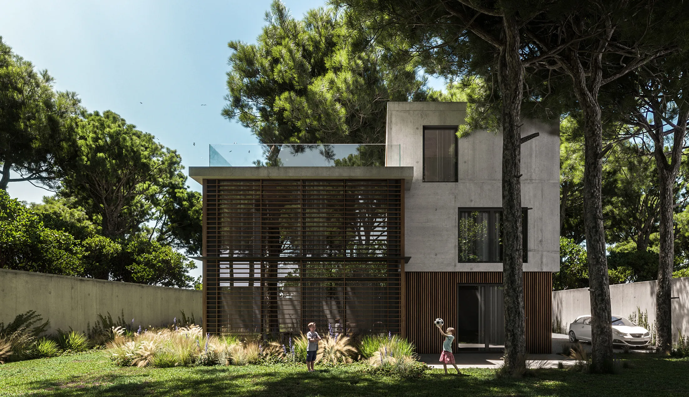 Jardín trasero de la villa con la fachada posterior entre los pinos al fondo