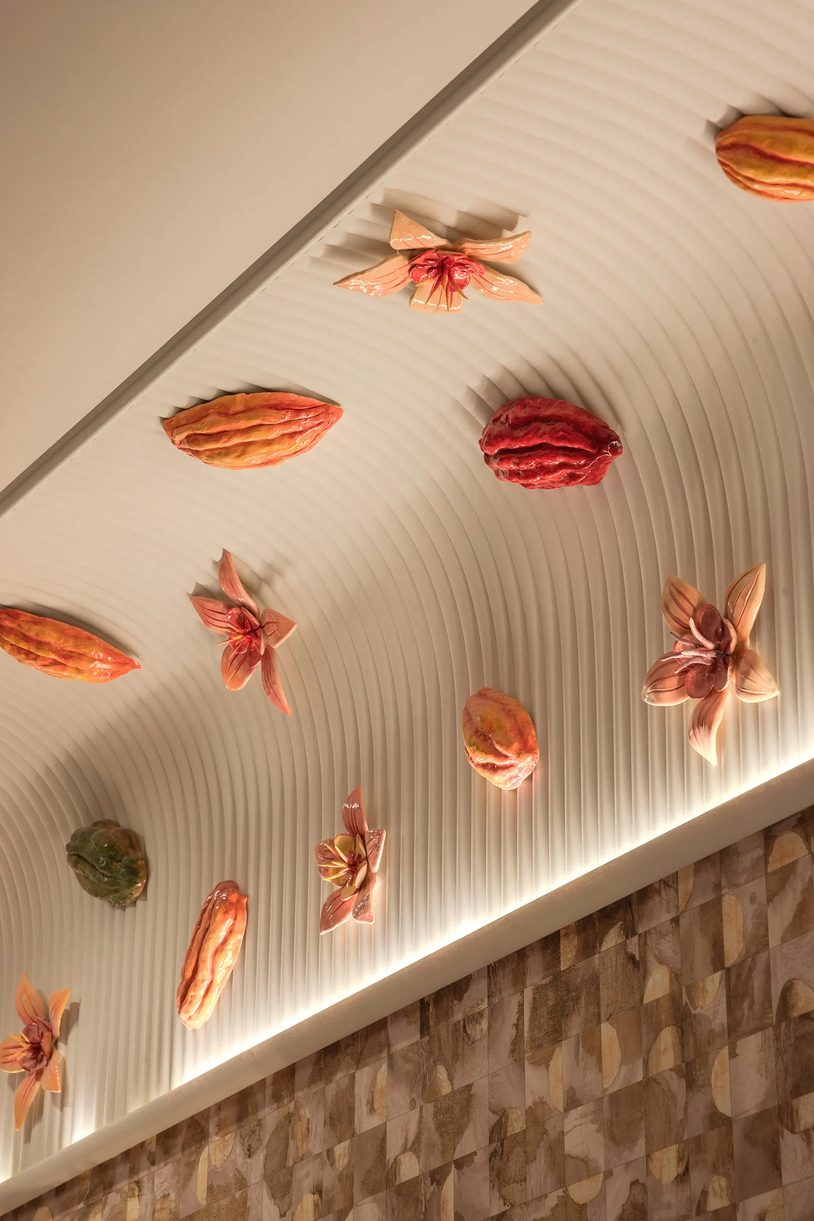 Handcrafted ceramic beans and flowers, illuminated