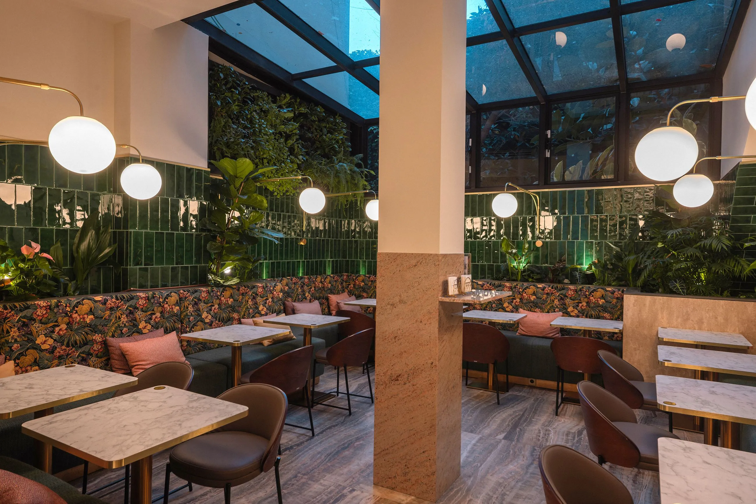 Interior terrace recreating a tropical garden with abundant vegetation