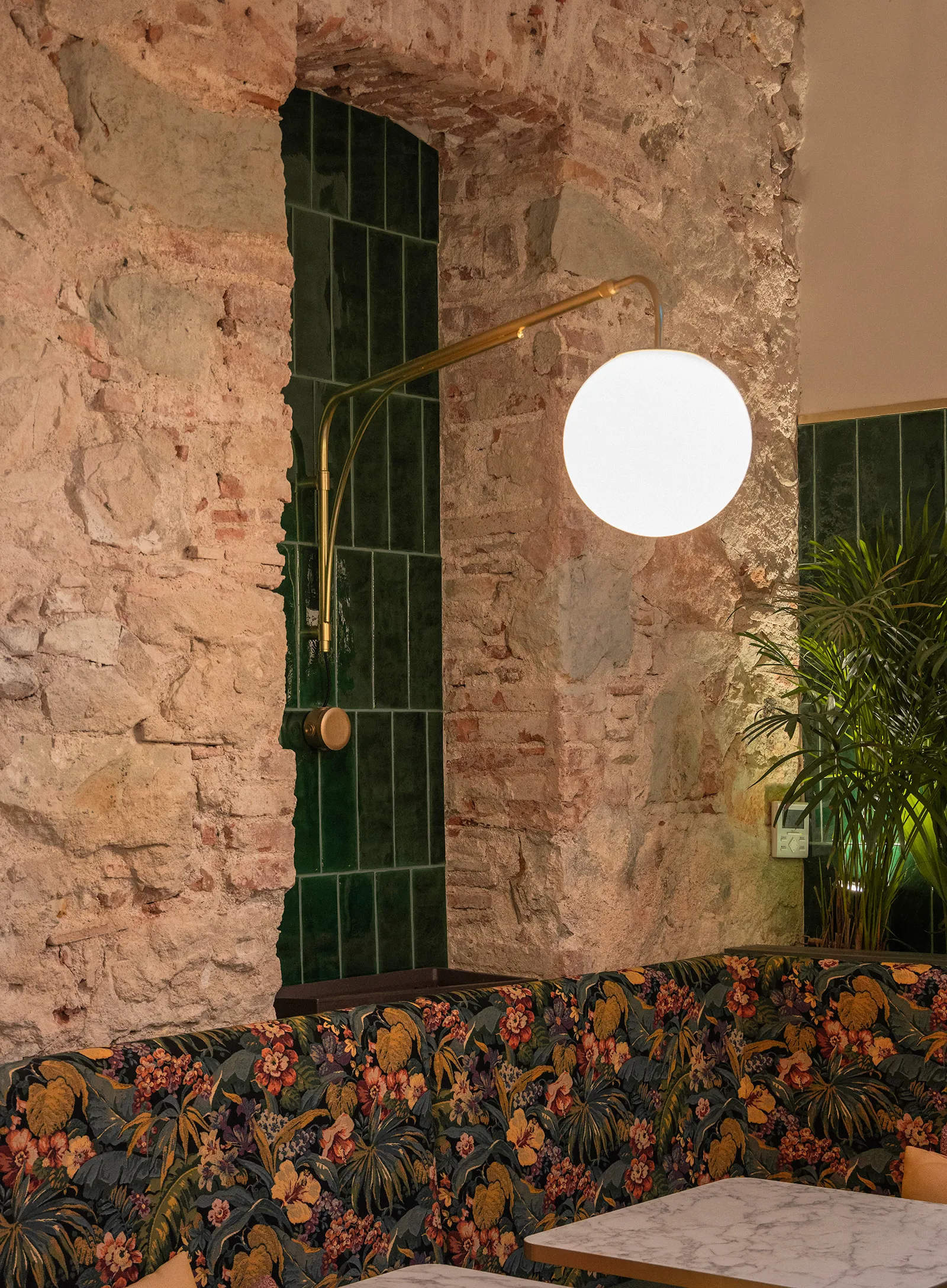 Original stone wall combined with glazed tile, upholstery and vegetation
